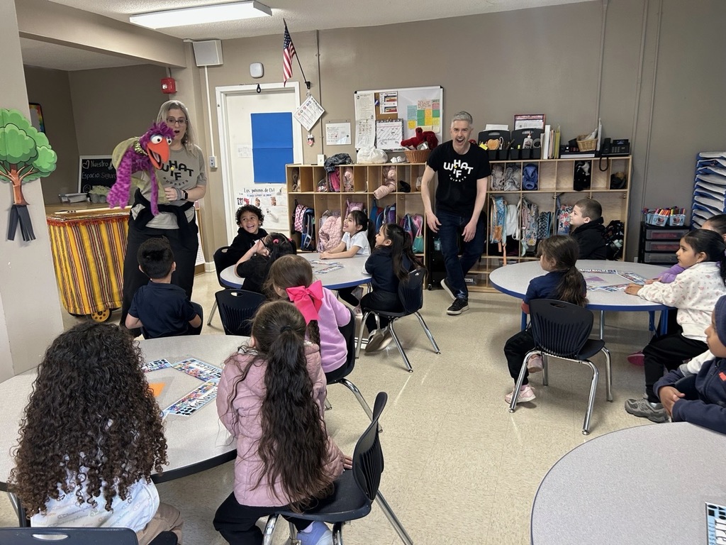 Children in the classroom, enjoying a fun activity with a bird puppet