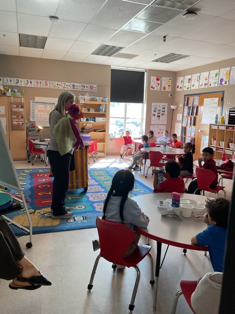 Children in the classroom, enjoying a fun activity with a bird puppet