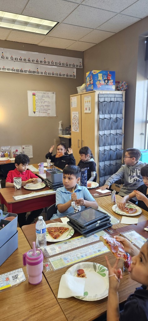 Students sitting and eating pizza