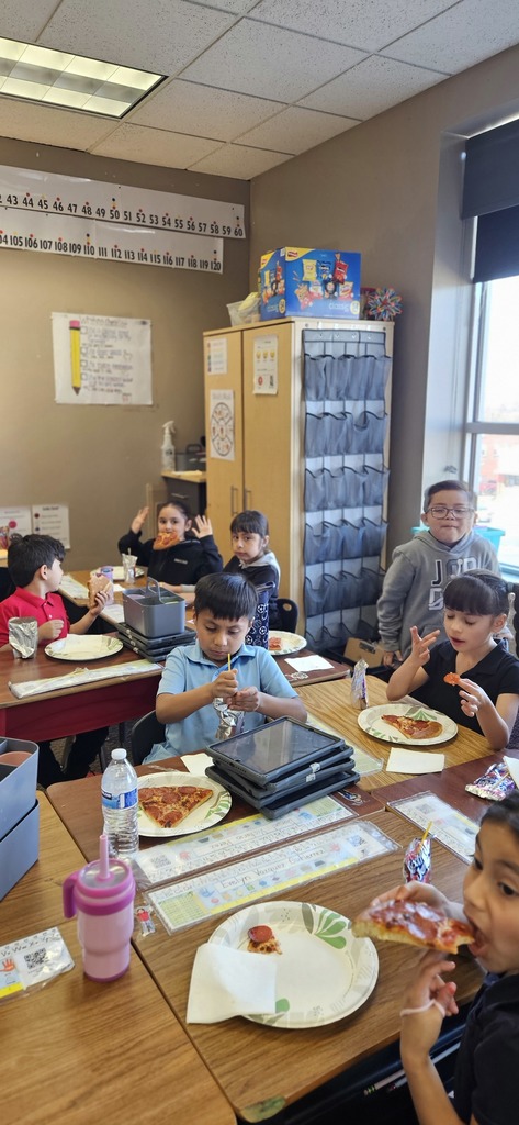Students sitting and eating pizza