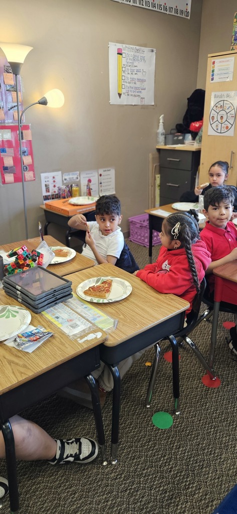 Students sitting and eating pizza