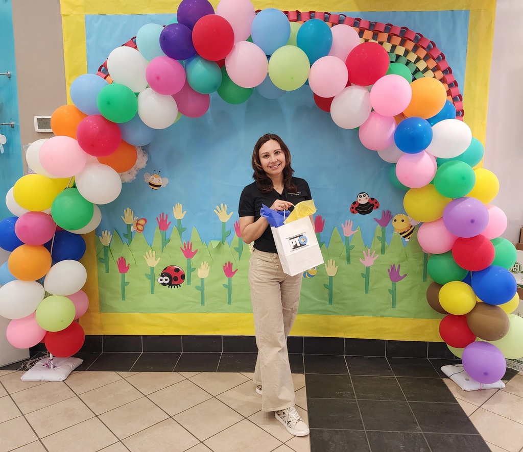 A woman with a gift bag; she is a Family Engagement (FACE) coordinator at an elementary school.