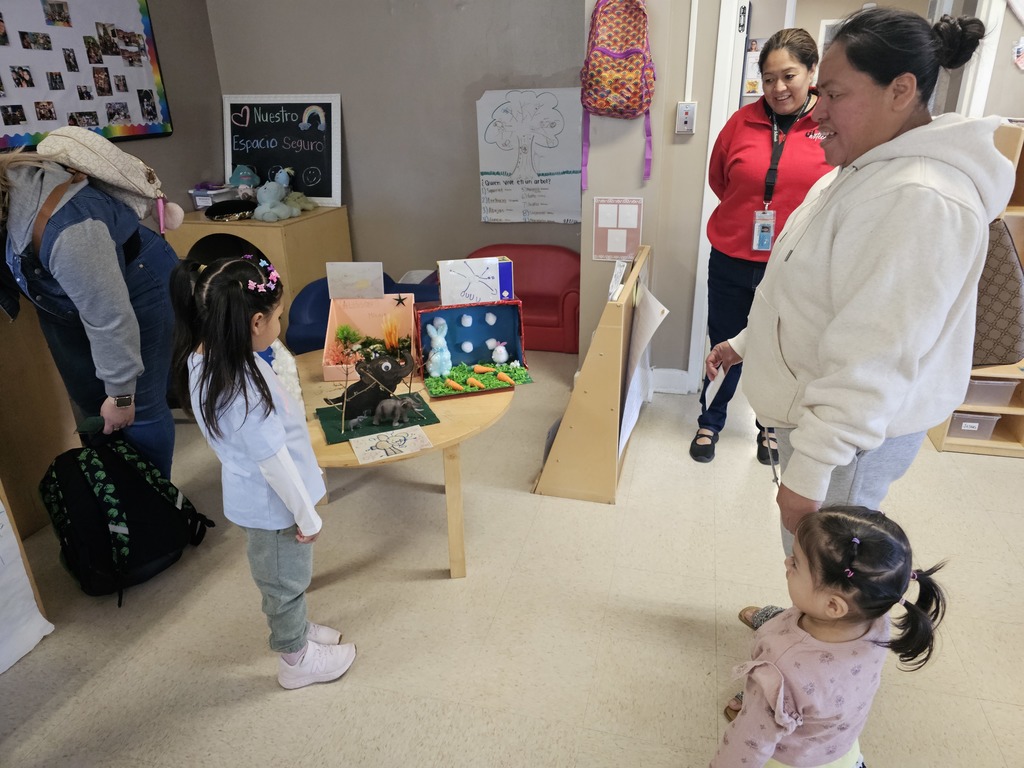 A Pre-K student with their mom. The student gave a demonstration for their family, explaining about animals and their habitat.