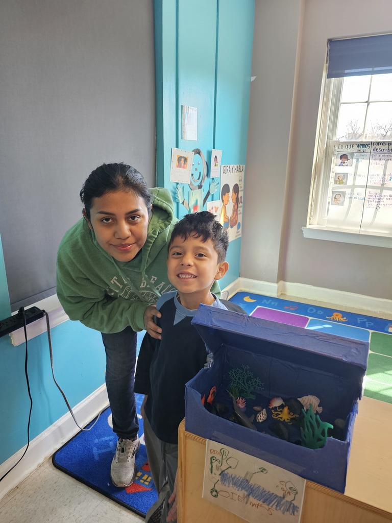 A Pre-K student with their mom. The student gave a demonstration for their family, explaining about animals and their habitat.