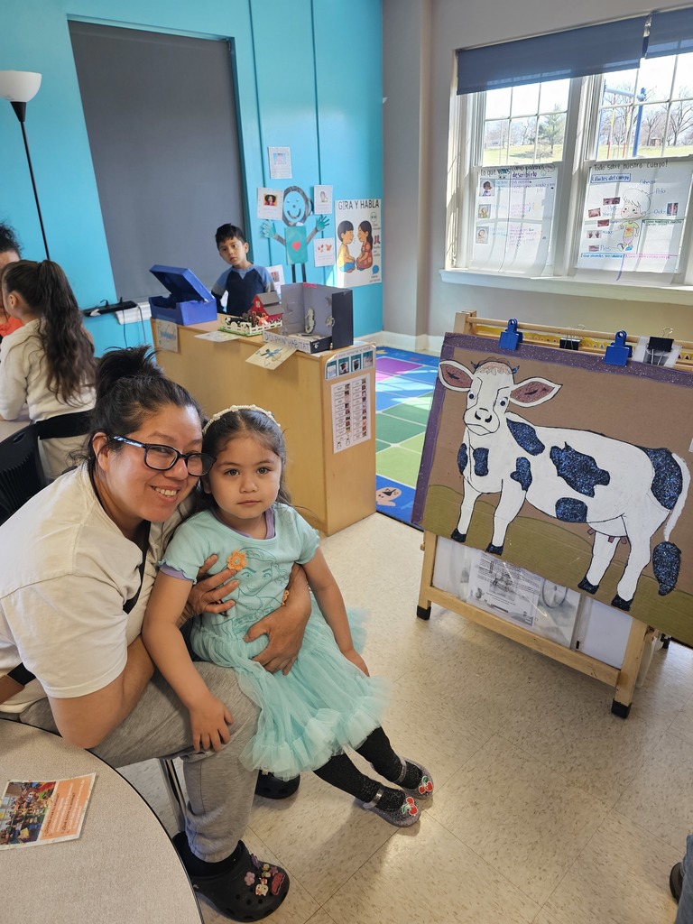 A Pre-K student with their mom. The student gave a demonstration for their family, explaining about animals and their habitat.