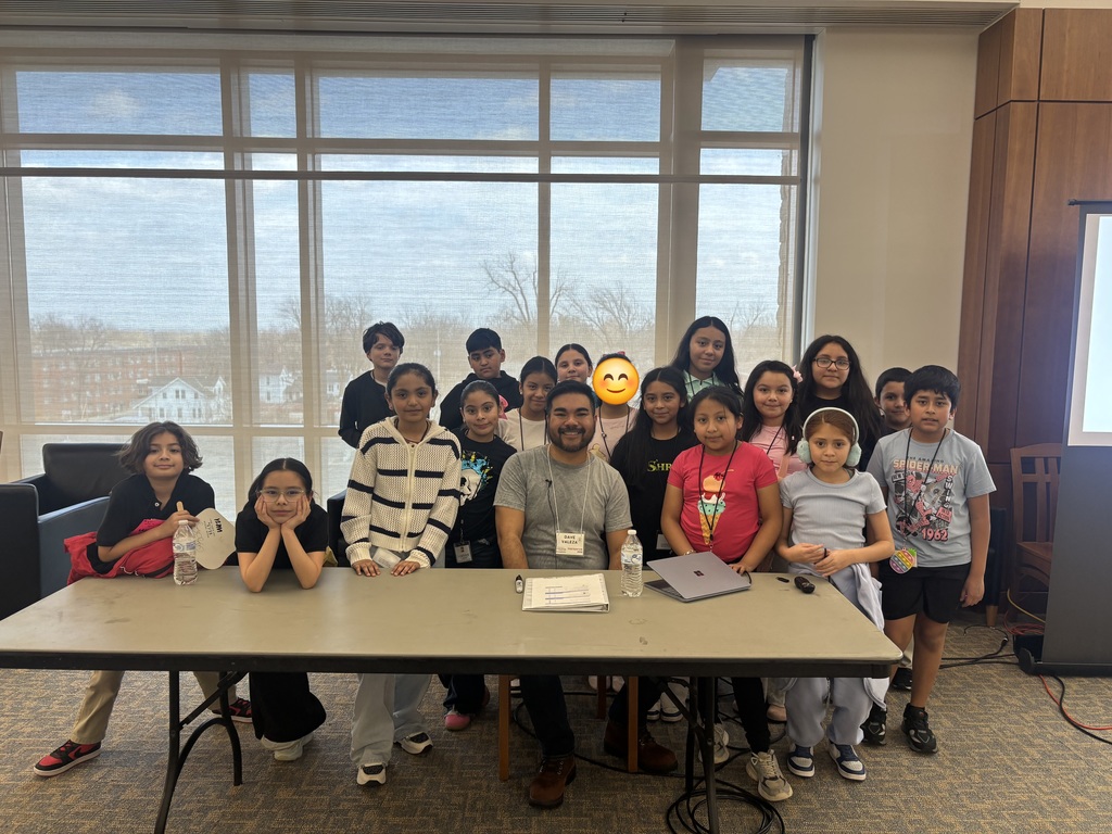 A group of 3rd–5th grade students with a well-known book illustrator.