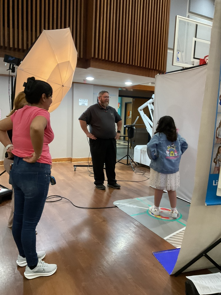 student getting ready to take a professional picture