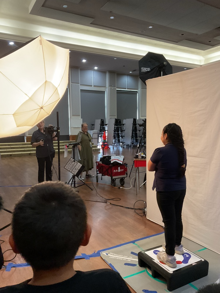 student getting ready to take a professional picture