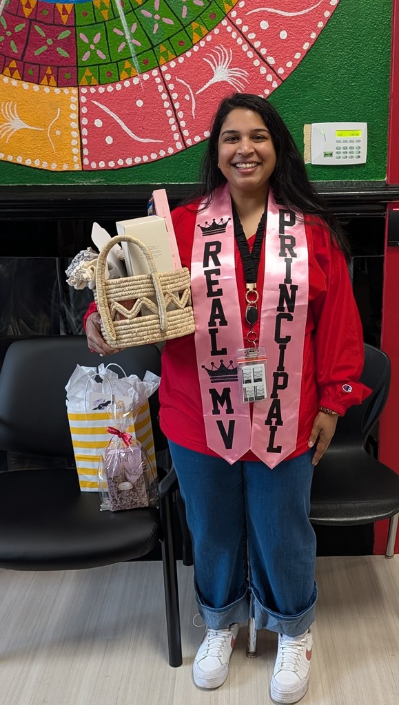 Assistant principal holding a basket with gifts. 