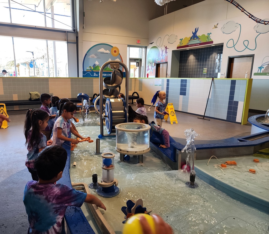 Kids enjoying a museum in the water area
