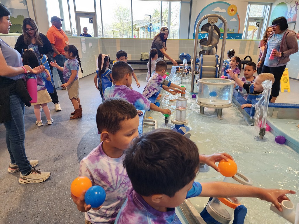 children playing in a museum at water area