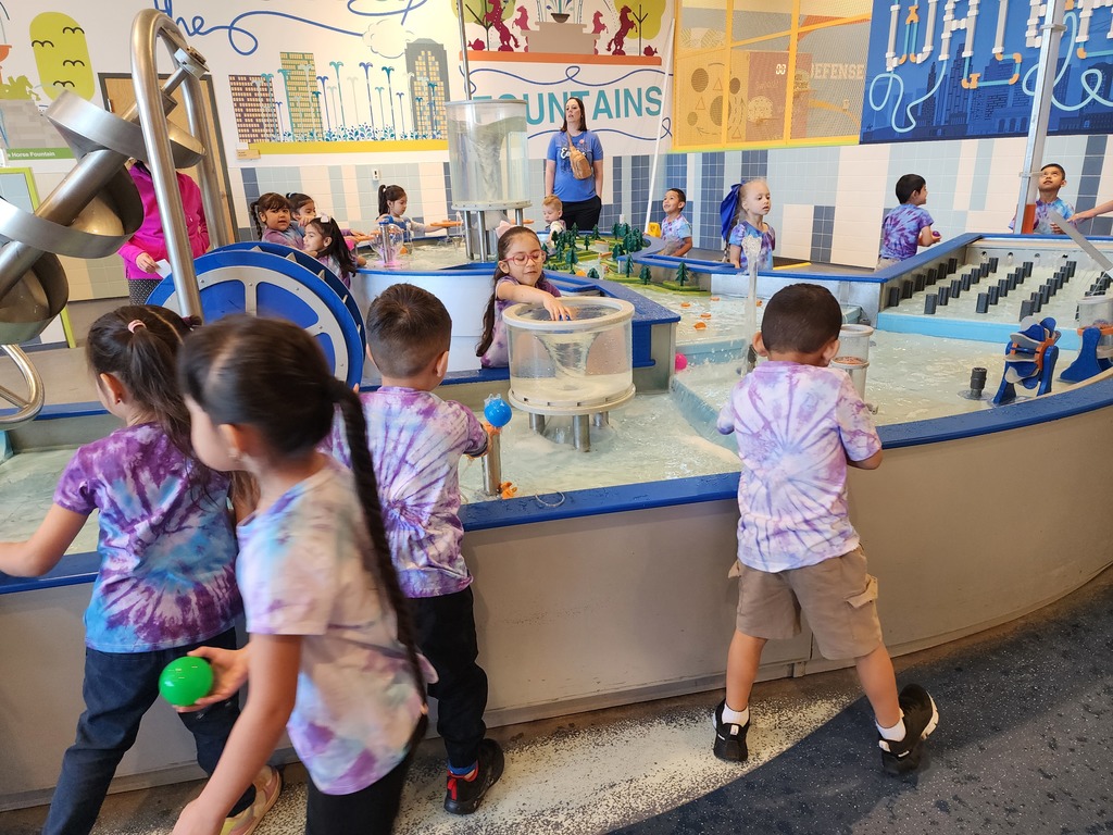 children playing in a museum in a water area 