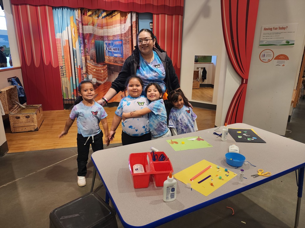 Children with their teacher posing for a photo at Wonderscope Children's Museum of Kansas City