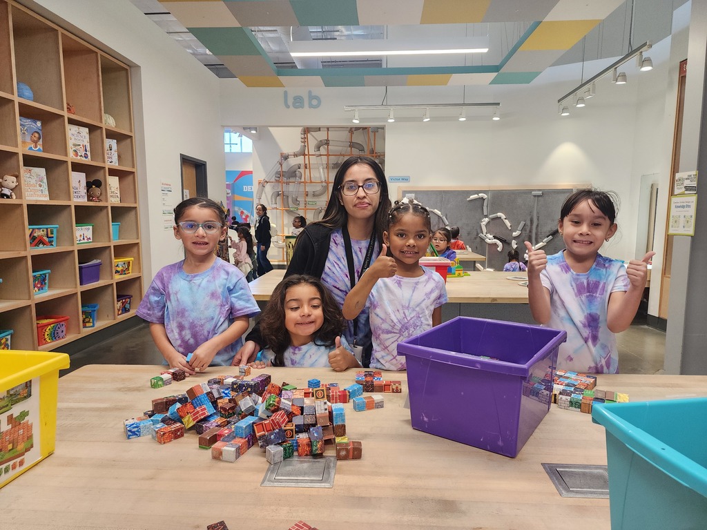 Children with their teacher posing for a photo at Wonderscope Children's Museum of Kansas City