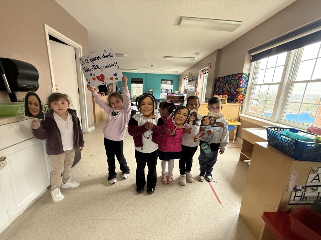 Children showing their appreciation to the assistant principal with signs.