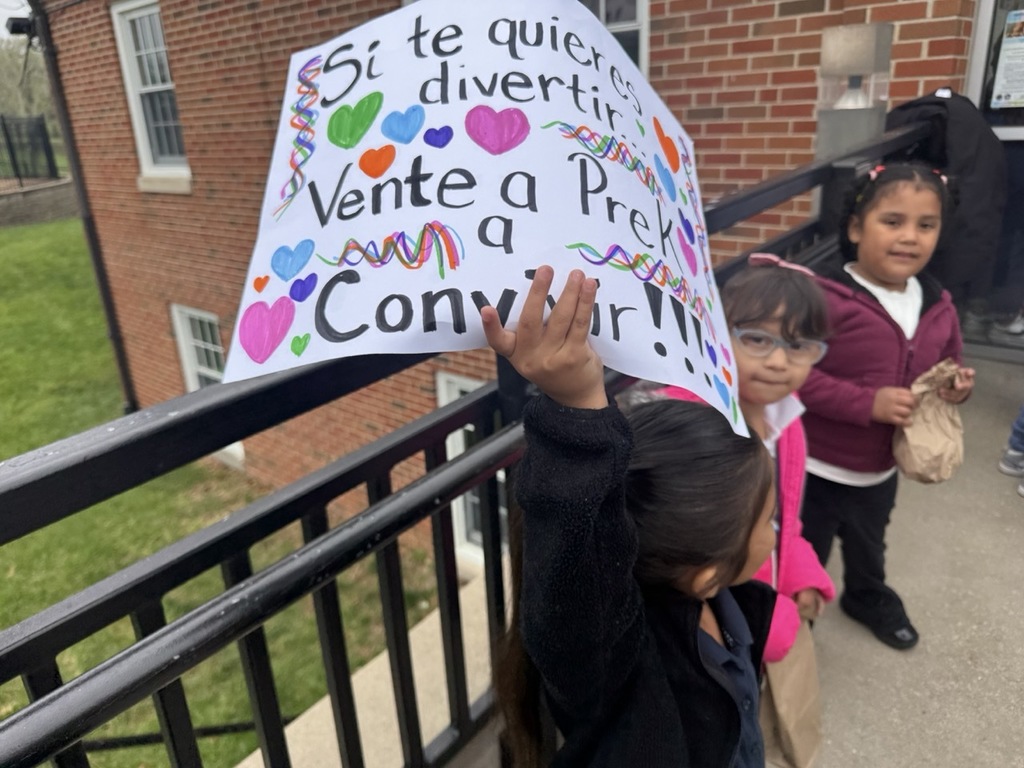 Children showing their appreciation to the assistant principal with signs.