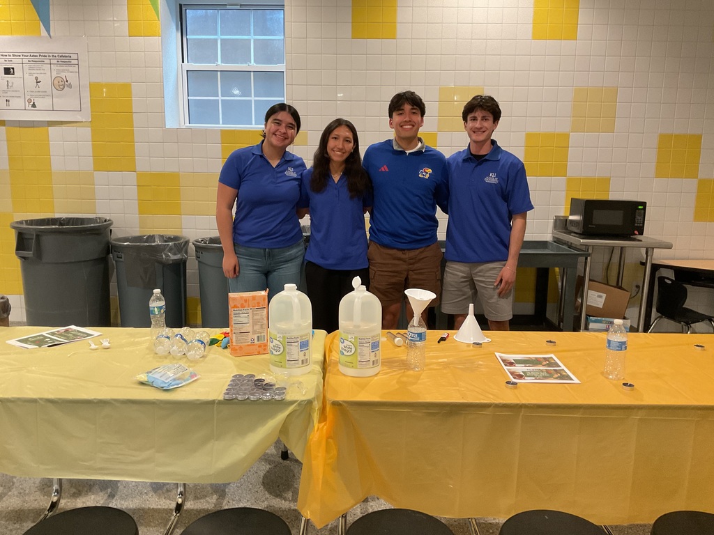 4 students posing for camera ready for an experiment 