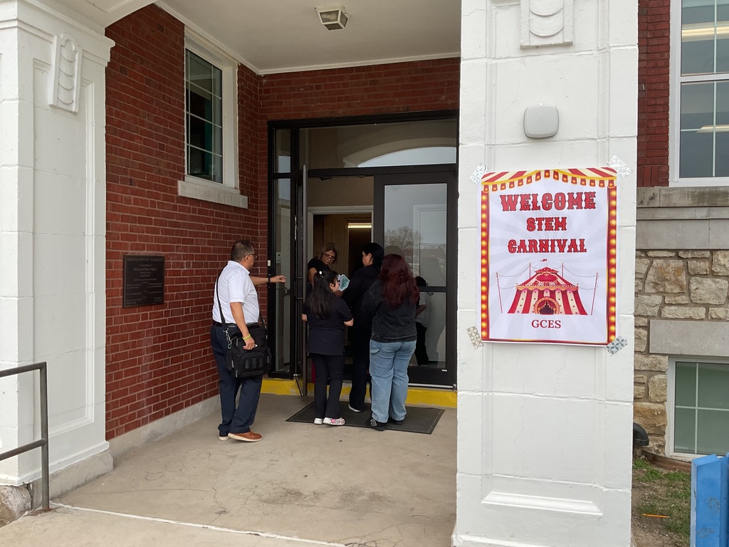 People entering a building for STEM night 