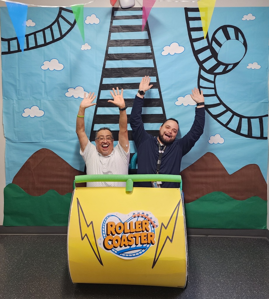 2 people on the roller coaster decoration with their hands up 