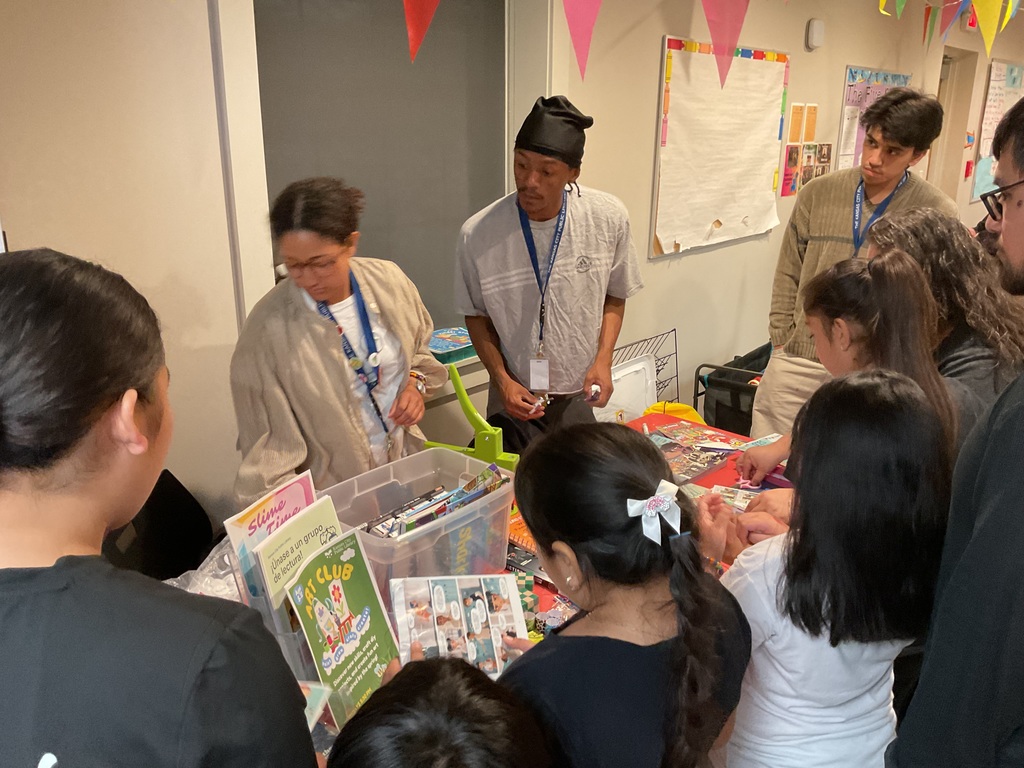 People around the KCPL table looking at books