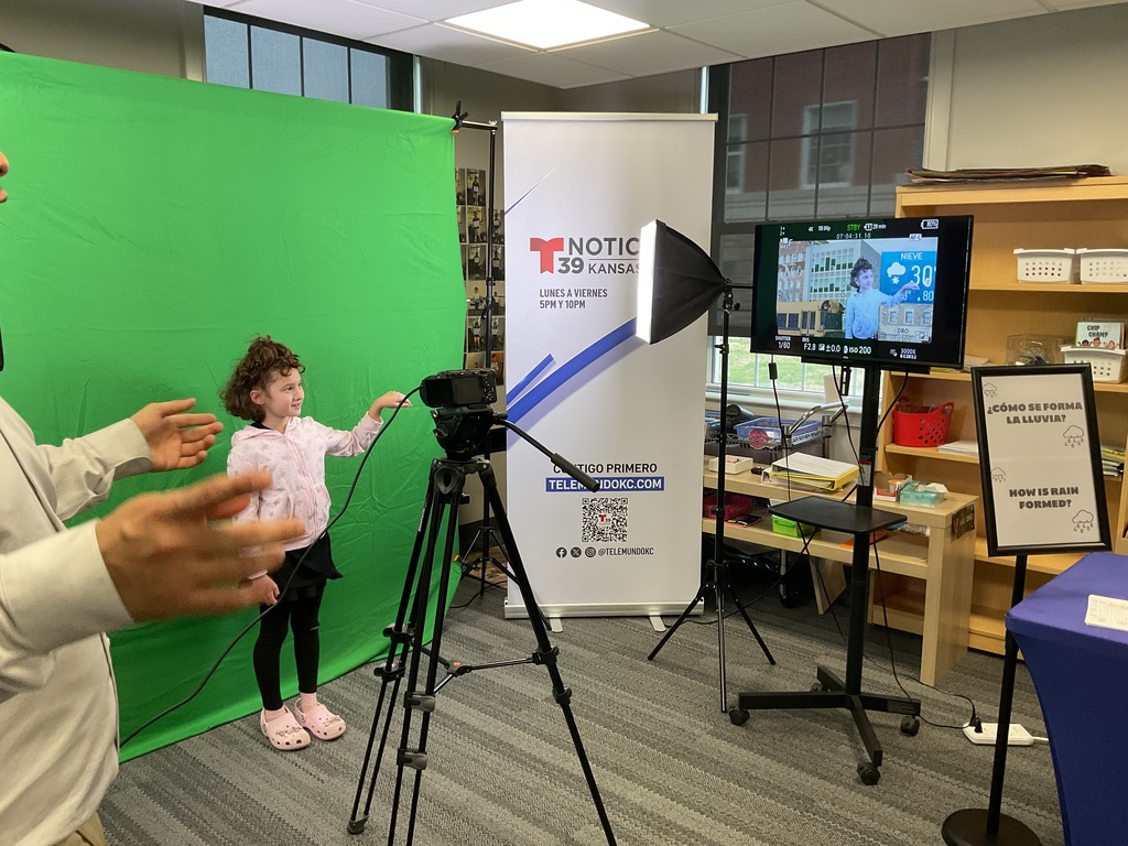 Student on a green screen giving the weather 