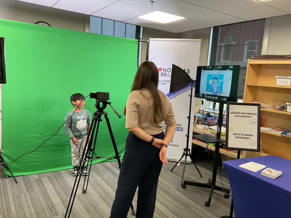 Student on a green screen giving the weather 