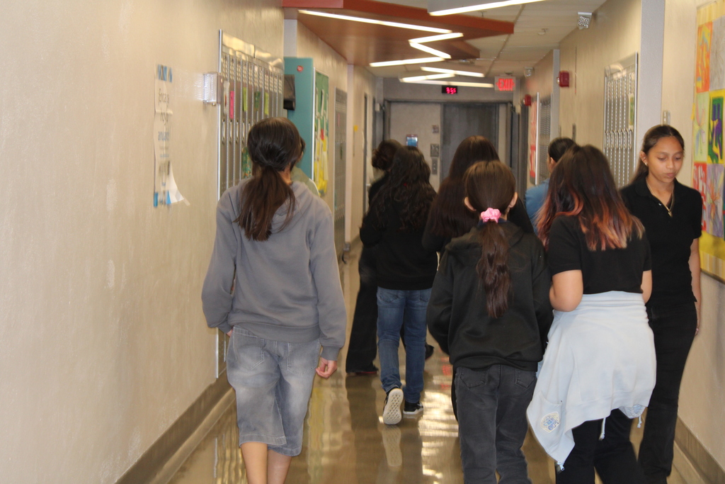8 students walking in the hallway 
