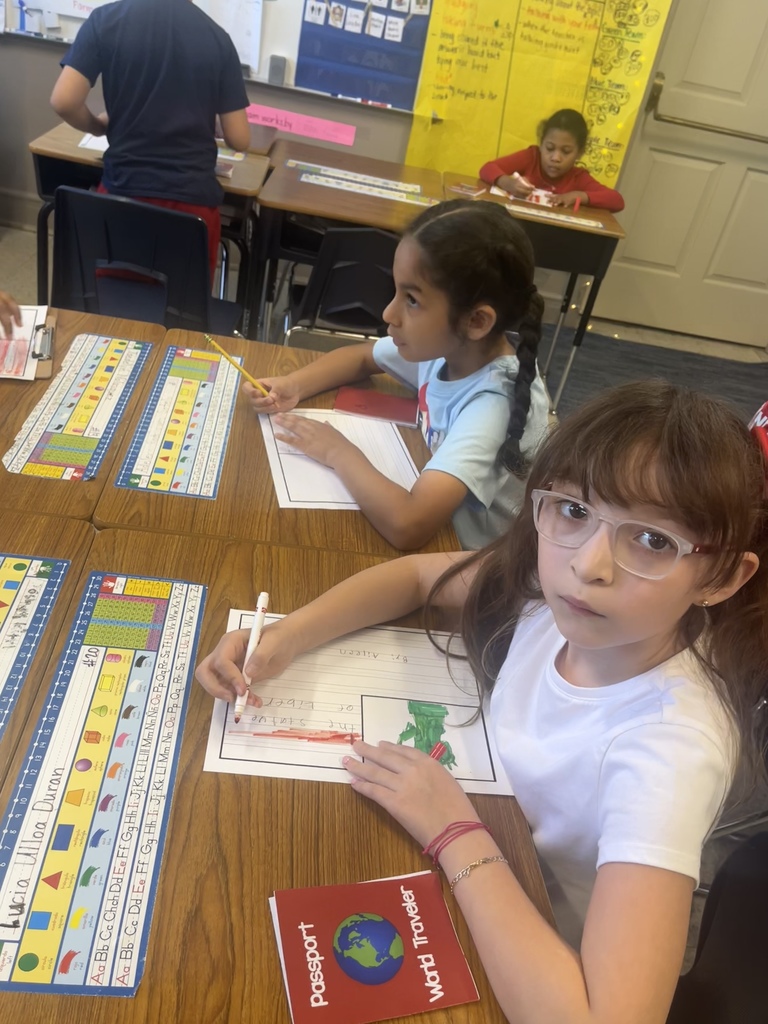 Students sitting on chair and desk writing