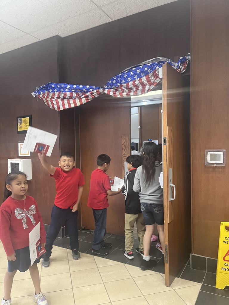Students entering the gym with their passports