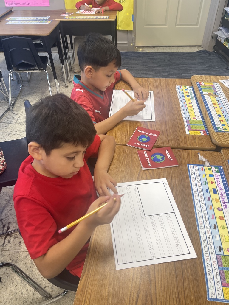 Students siting on chair and desk writing 