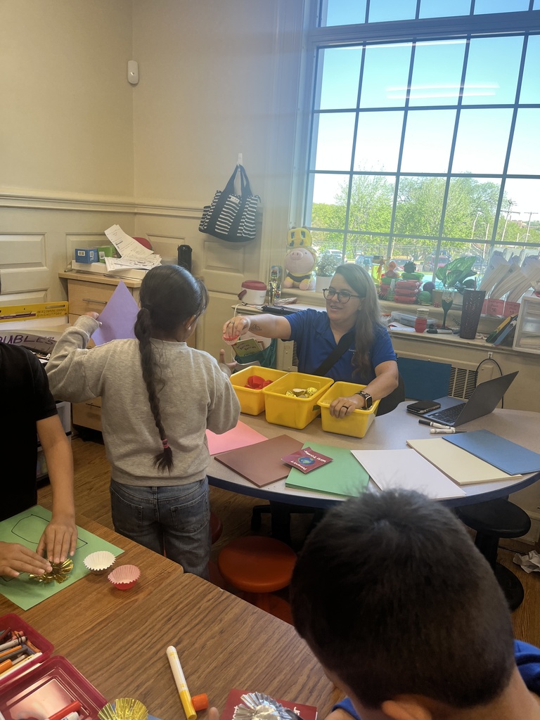 Teacher pointing to a student's work  while student shows it. 