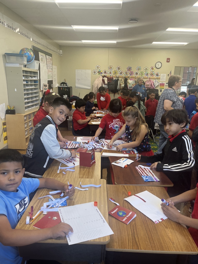 A group of students working on paper with the American Flag