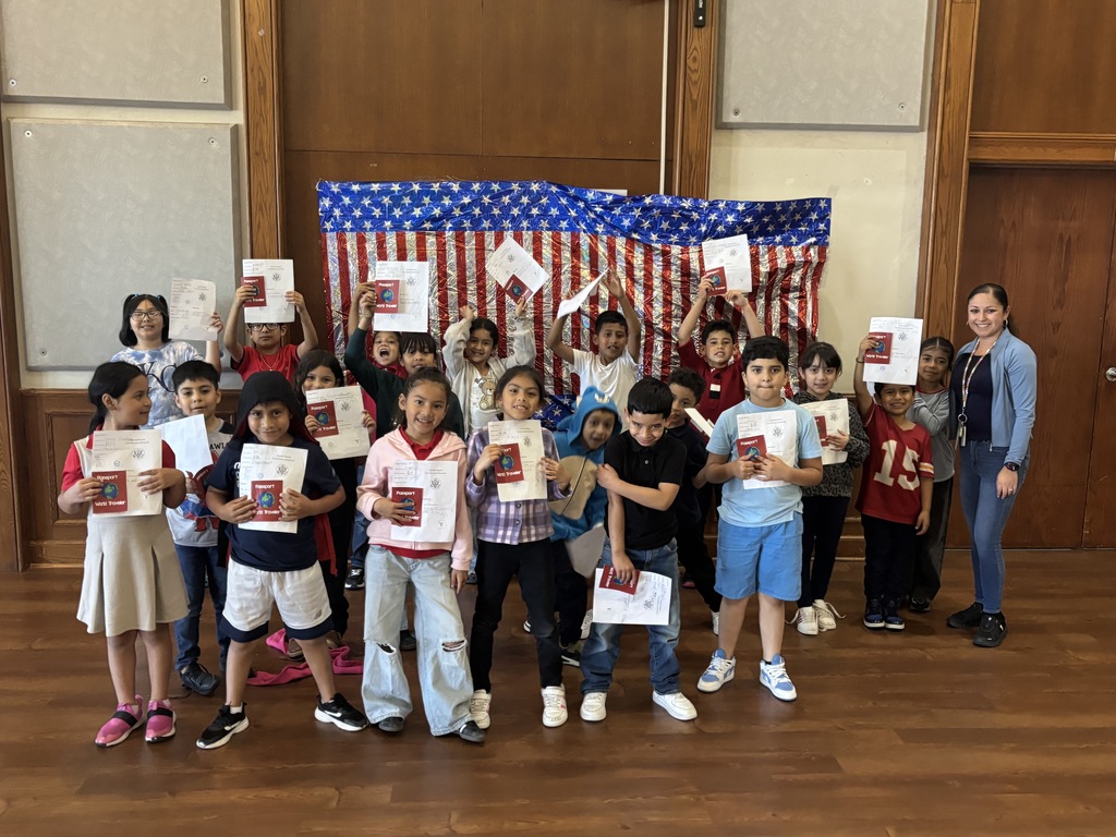 A group of students showing their passport with an american flag background.
