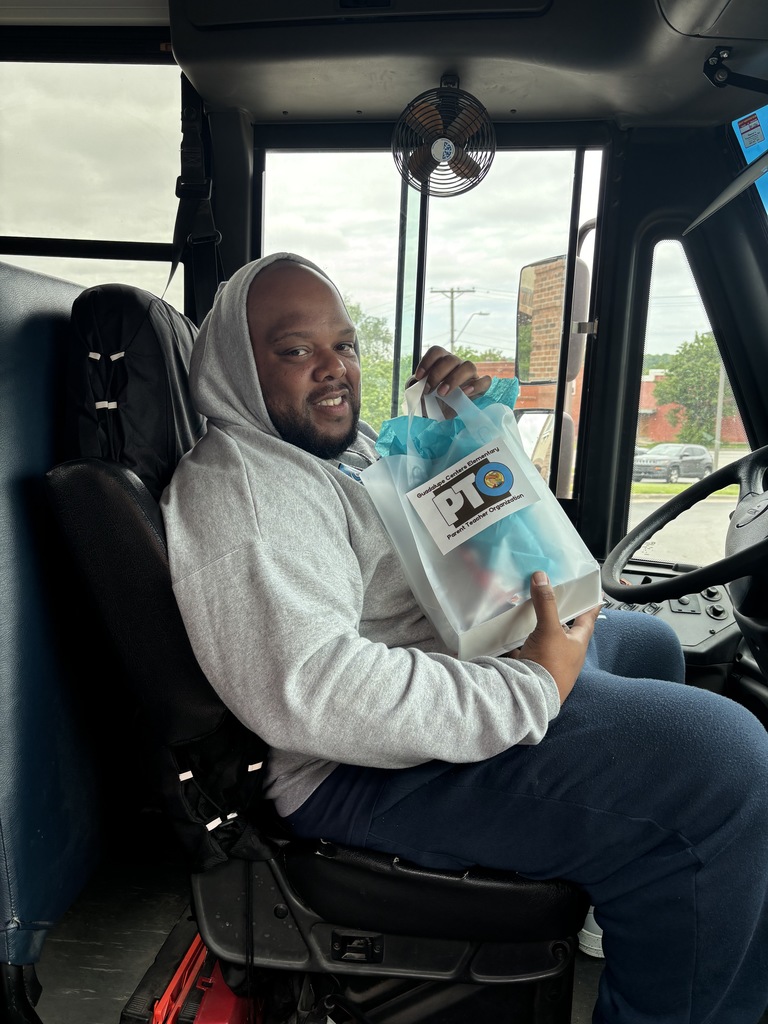 A male school bus driver with gift