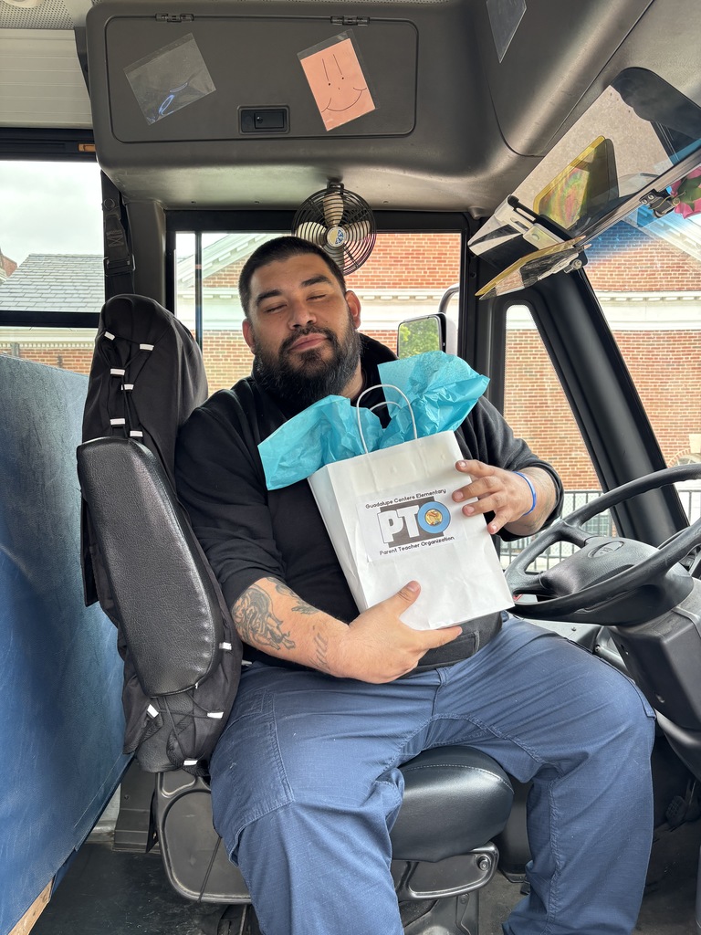 A male school bus driver with gift