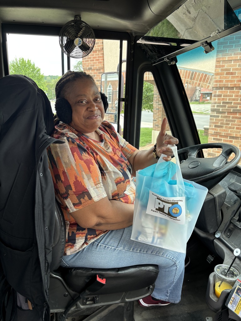 A female school bus driver with gift