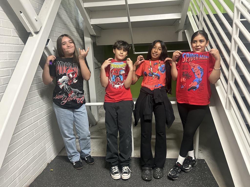 4 fifth-grade boys wearing T-shirts of their favorite characters.