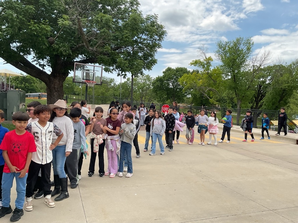 A line of children waiting to receive their popsicles, wearing their favorite outfits. It is the day we celebrate our children.