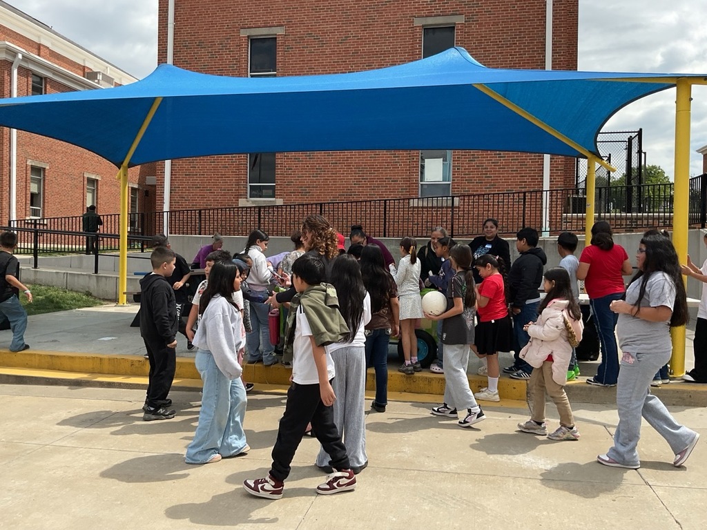 Children dressed in their favorite outfits, receiving popsicles during the Children’s Day celebration.