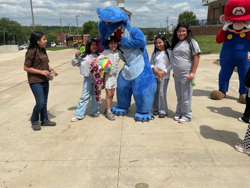 Five girls having fun, playing with a volleyball, and spending time with the Stitch character.