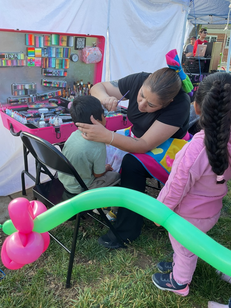 a woman doing face painting 