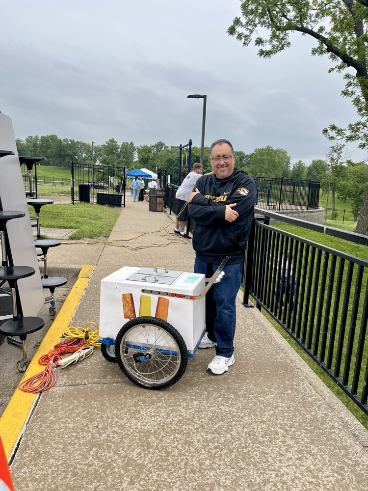 a man with a popsicle cart 