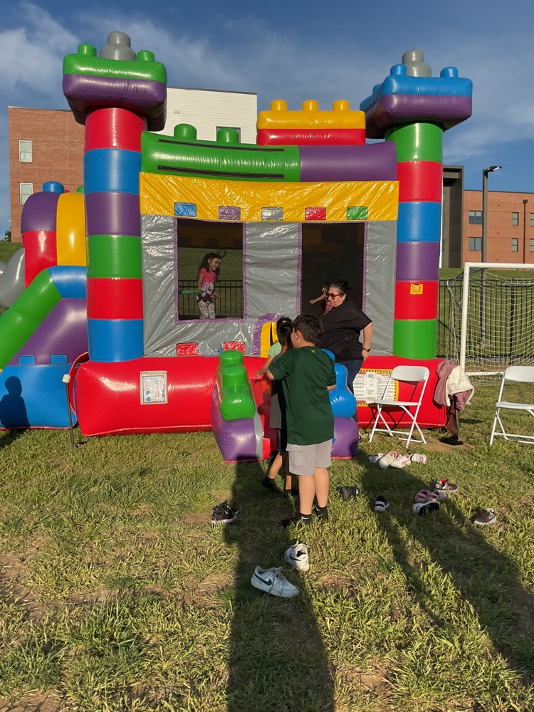 kids jumping in an inflatable castle