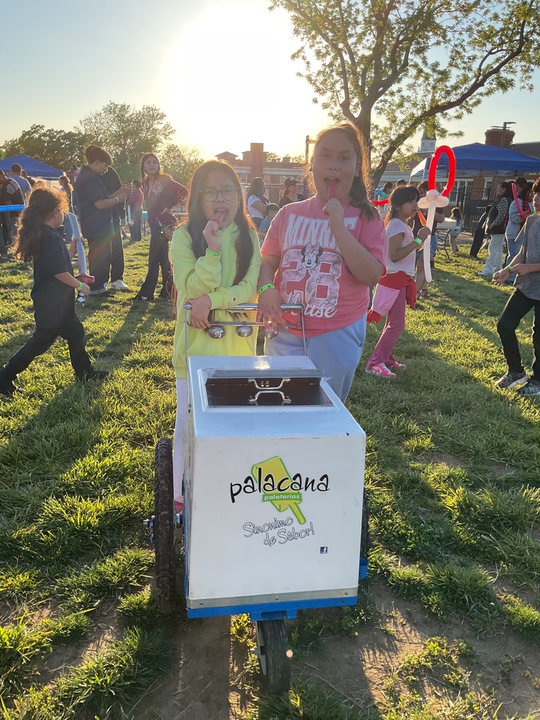 2 girls selling popsicles in a cart