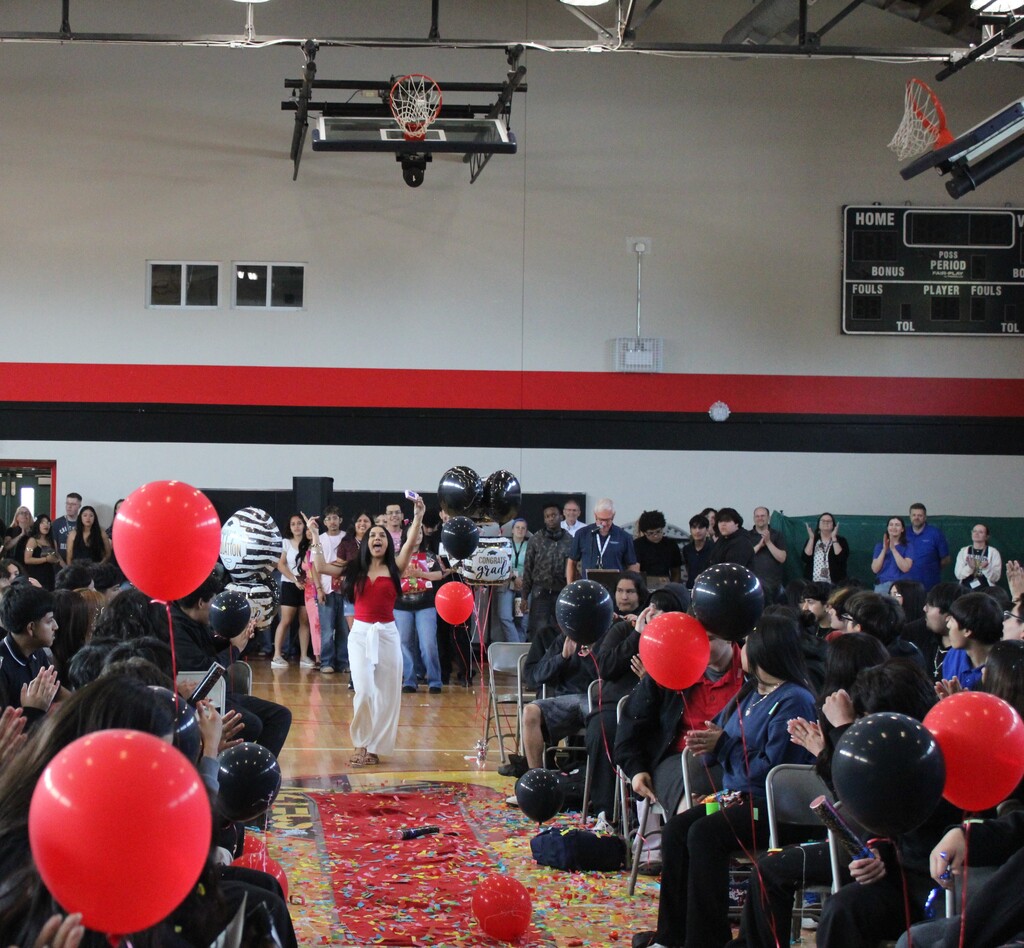 student walking and students cheering  