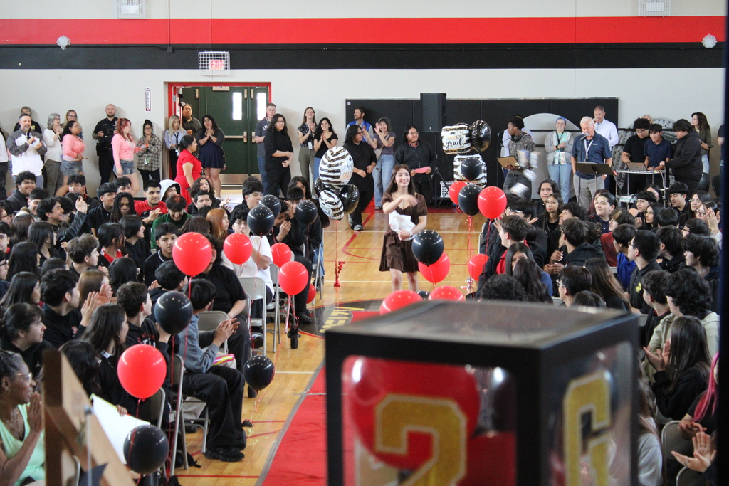 student walking and students cheering  