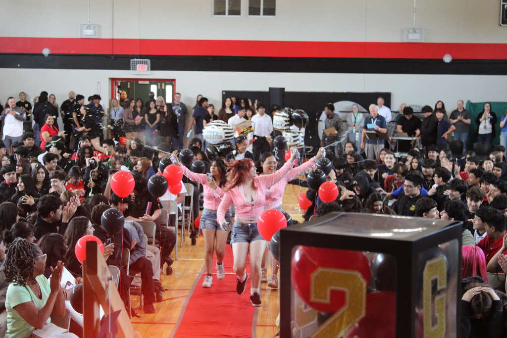 student walking and students cheering  