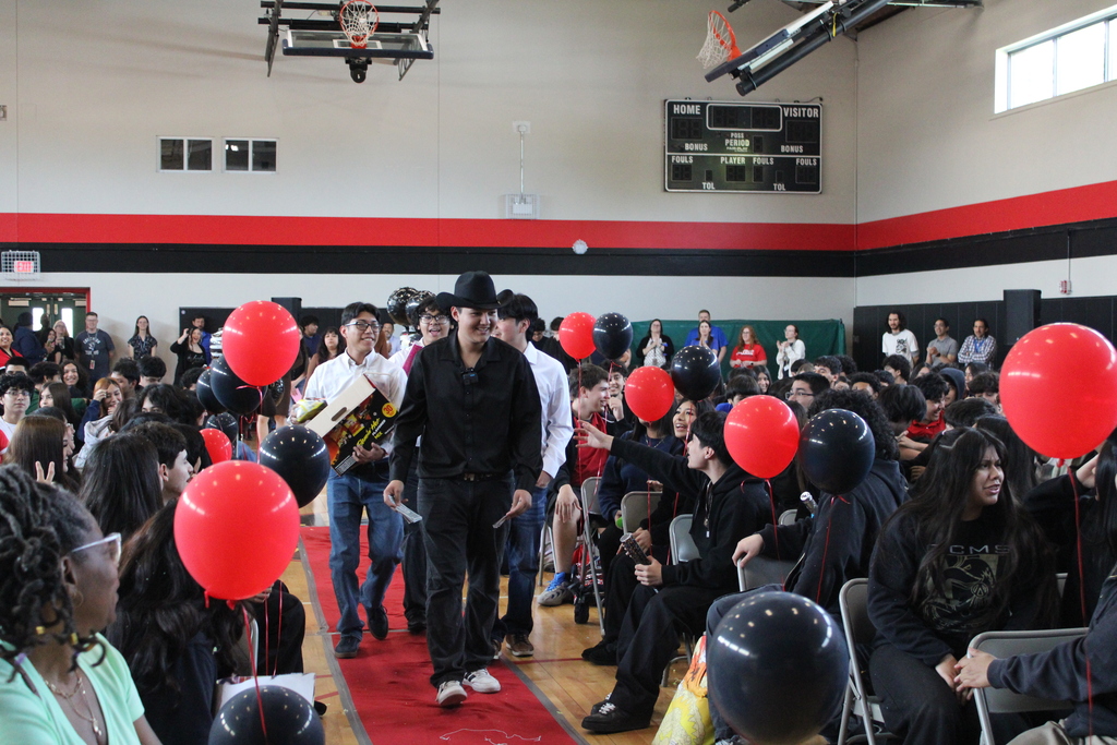 student walking and students cheering  