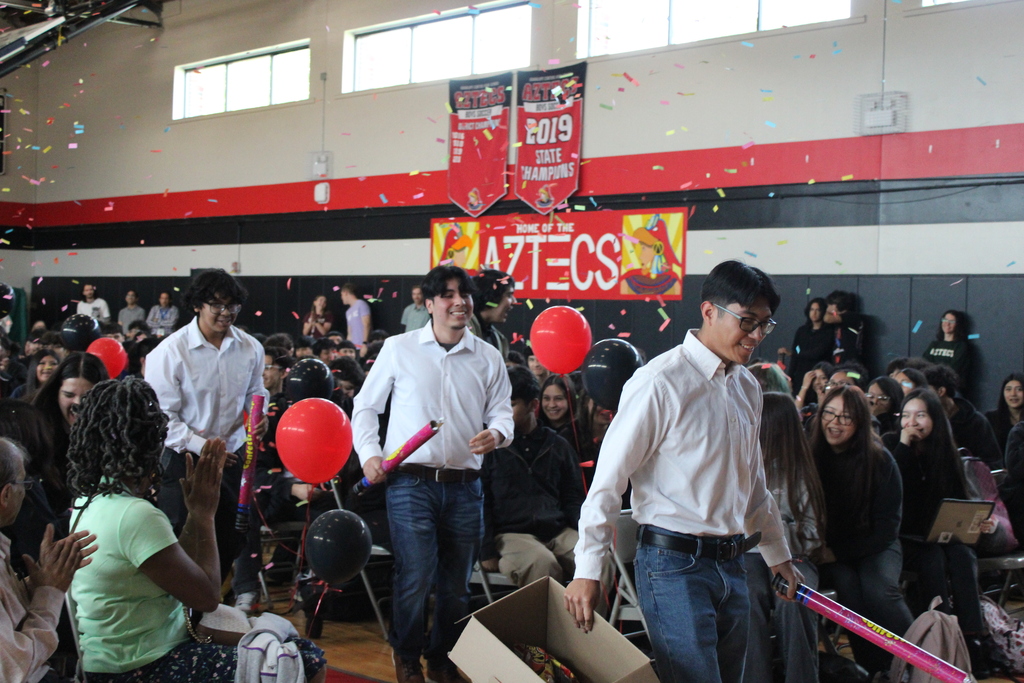 student walking and students cheering  
