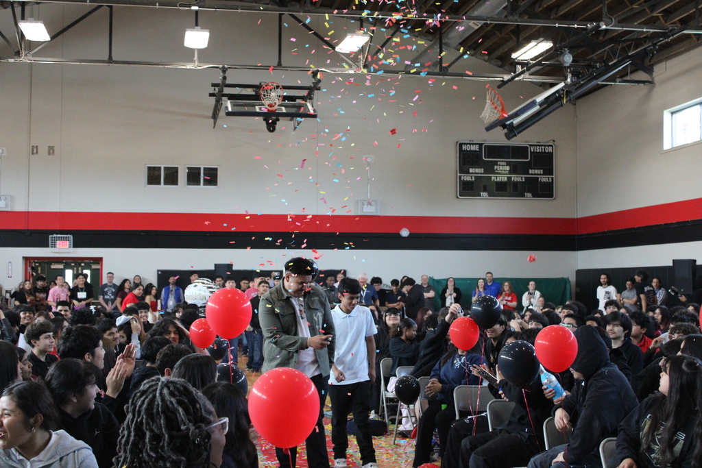 student walking and students cheering  